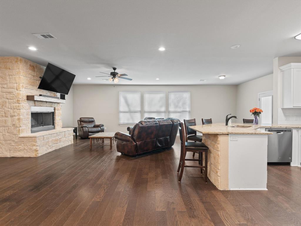 a living room with furniture flat screen tv and appliances