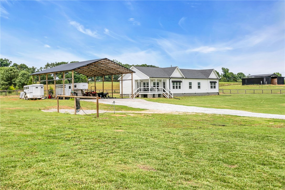615 Wilson Road Central, SC 29630 - Photo 38 of 50 A spacious country property features a modern home surrounded by green acreage and versatile outbuildings.