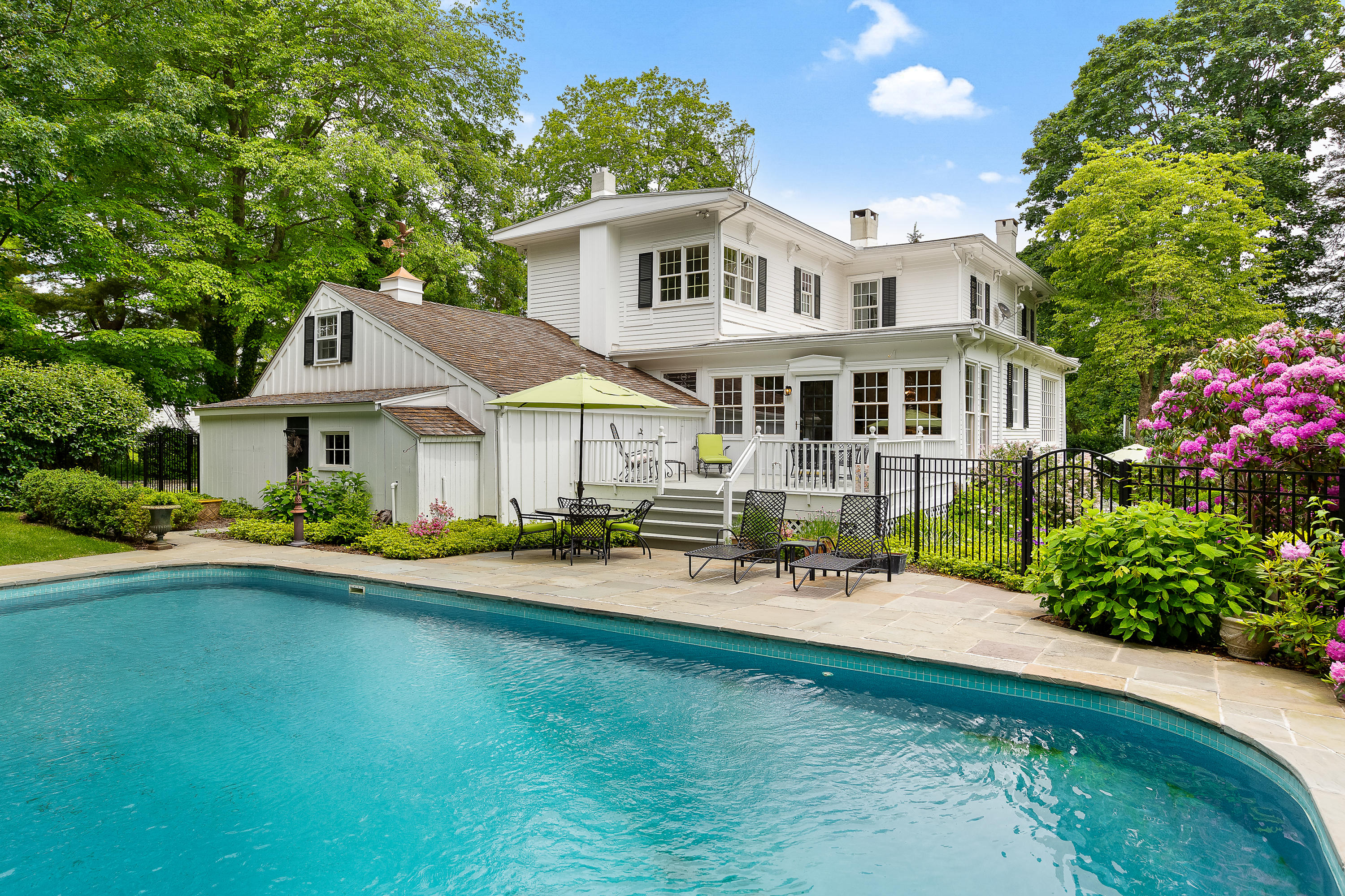 a front view of a house with garden and porch