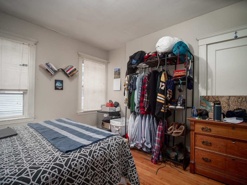 60 Powder House Boulevard, Unit 2 Somerville, MA 02144 - Photo 17 of 42 a bedroom with a bed and a closet