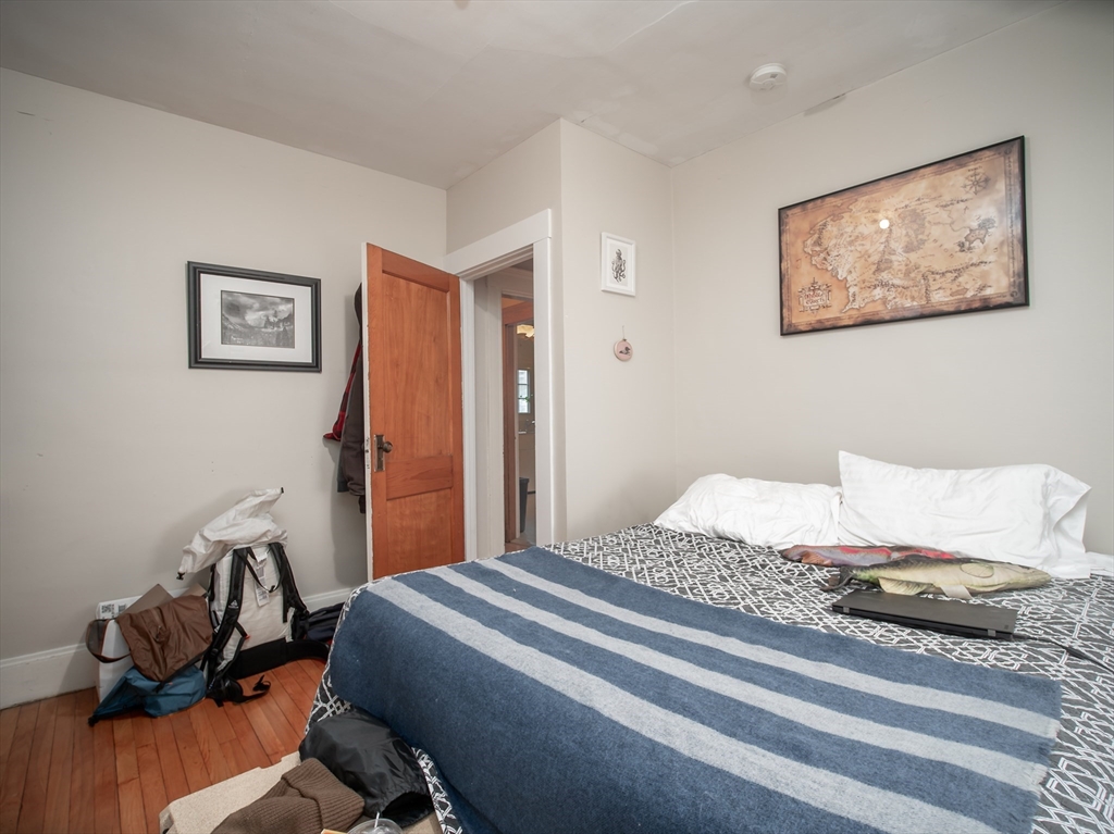 60 Powder House Boulevard, Unit 2 Somerville, MA 02144 - Photo 19 of 42 a bedroom that has a bed and a chair in it