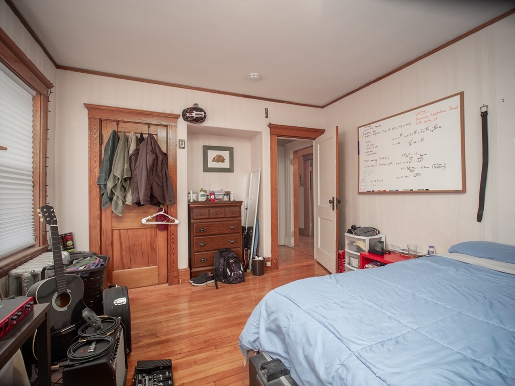 60 Powder House Boulevard, Unit 2 Somerville, MA 02144 - Photo 22 of 42 a bed room with a bed and a television