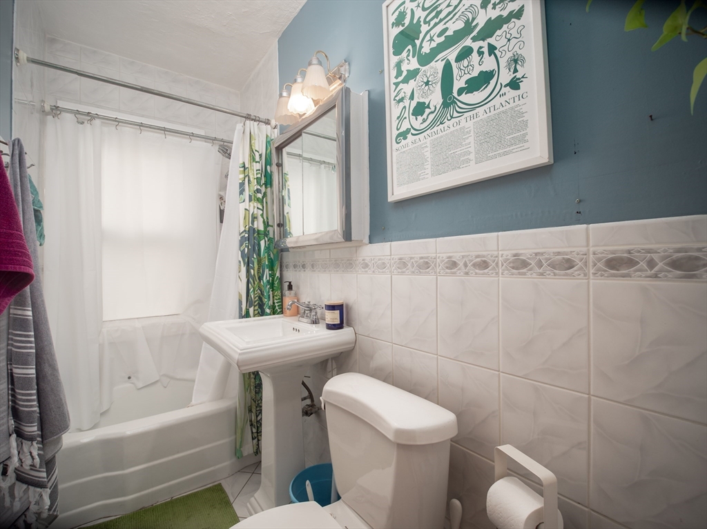 60 Powder House Boulevard, Unit 2 Somerville, MA 02144 - Photo 23 of 42 a bathroom with a sink toilet and shower