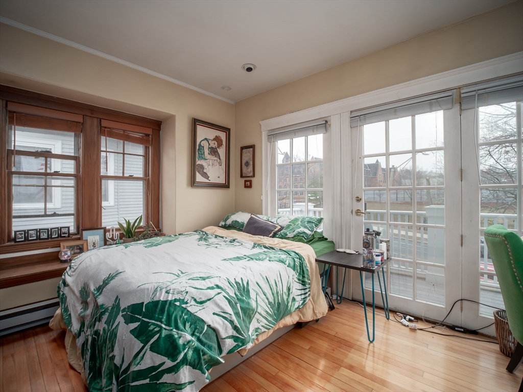 60 Powder House Boulevard, Unit 2 Somerville, MA 02144 - Photo 24 of 42 a bedroom with a bed and a large window