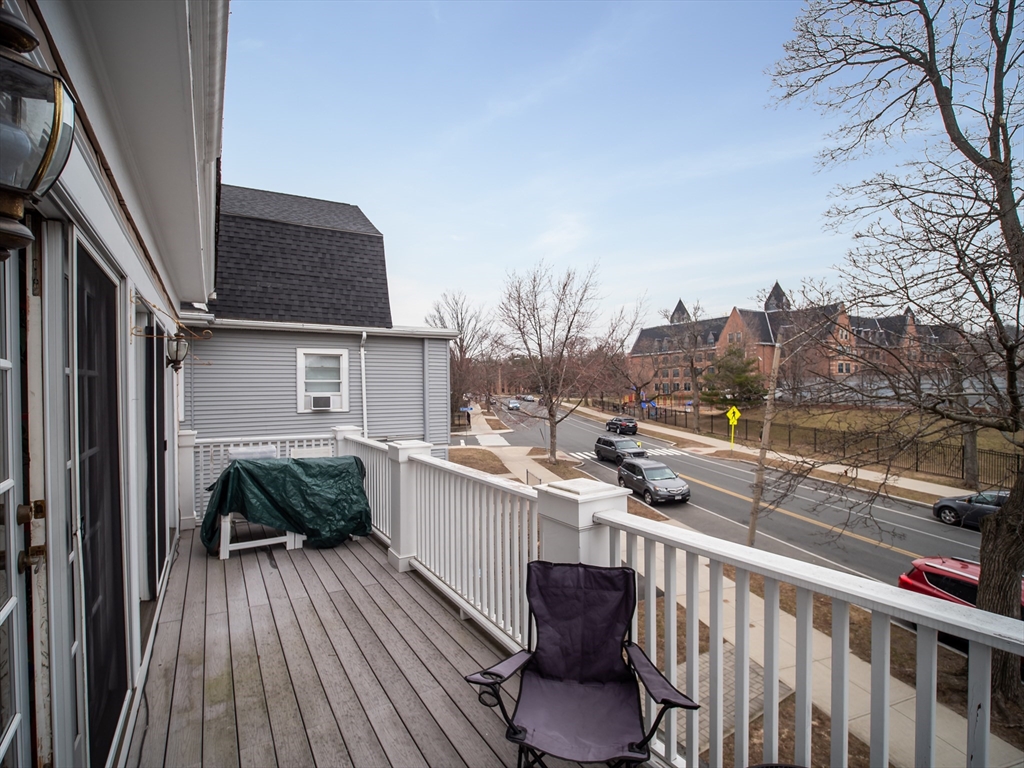 60 Powder House Boulevard, Unit 2 Somerville, MA 02144 - Photo 27 of 42 a view of balcony with furniture and wooden deck