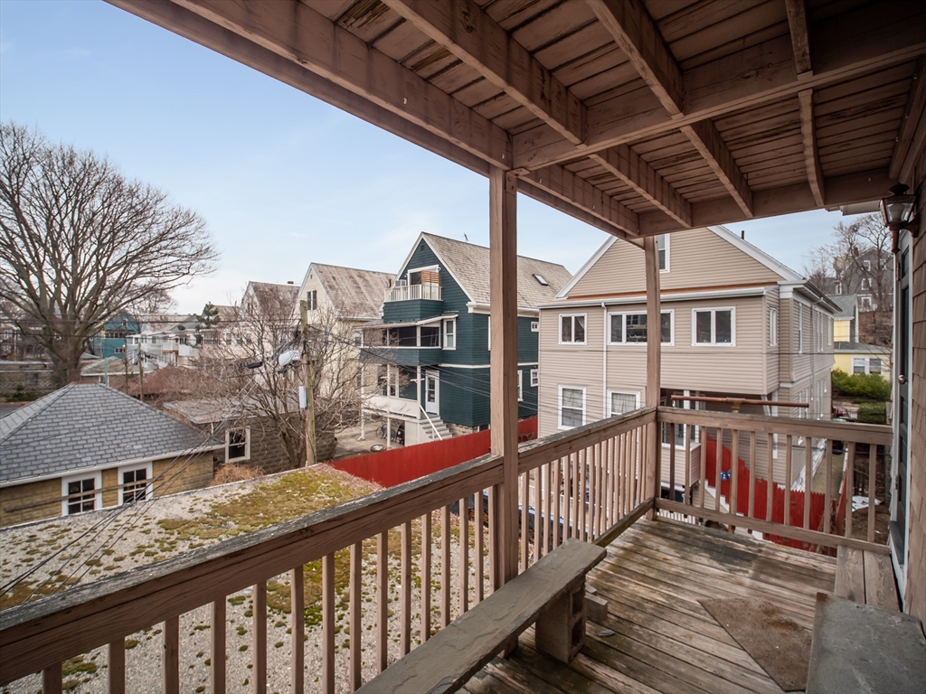 60 Powder House Boulevard, Unit 2 Somerville, MA 02144 - Photo 30 of 42 a view of a street with wooden fence