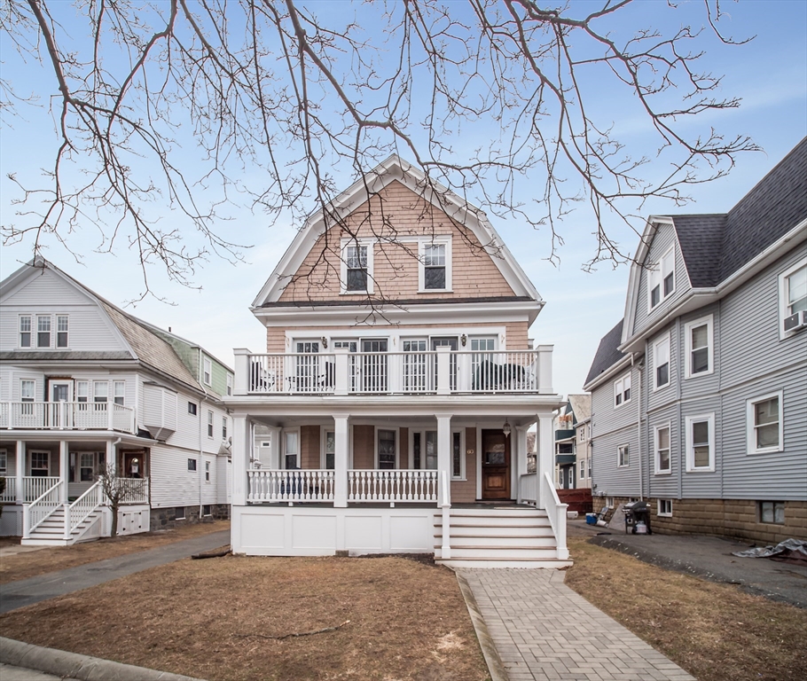 60 Powder House Boulevard, Unit 2 Somerville, MA 02144 - Photo 32 of 42 a front view of a building with a yard