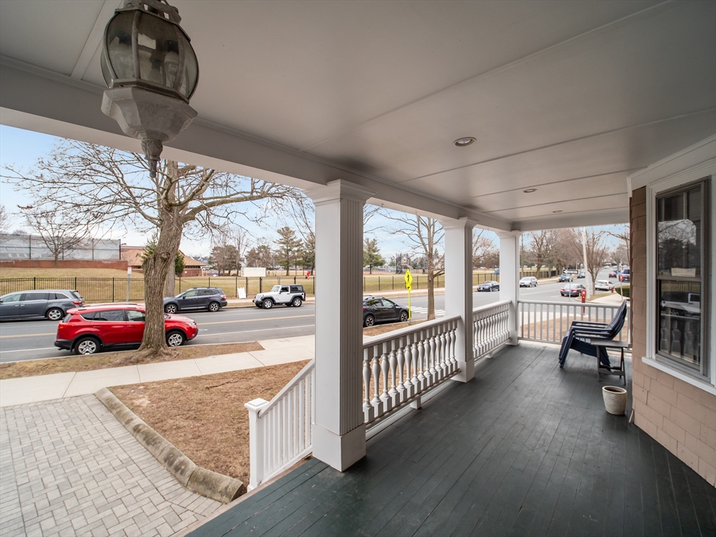 60 Powder House Boulevard, Unit 2 Somerville, MA 02144 - Photo 36 of 42 a view of a porch area with furniture and floor to ceiling window