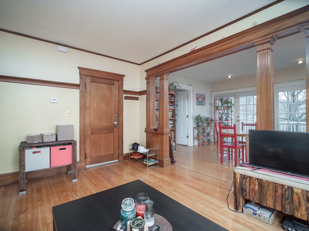 60 Powder House Boulevard, Unit 2 Somerville, MA 02144 - Photo 4 of 42 a living room with furniture and a flat screen tv