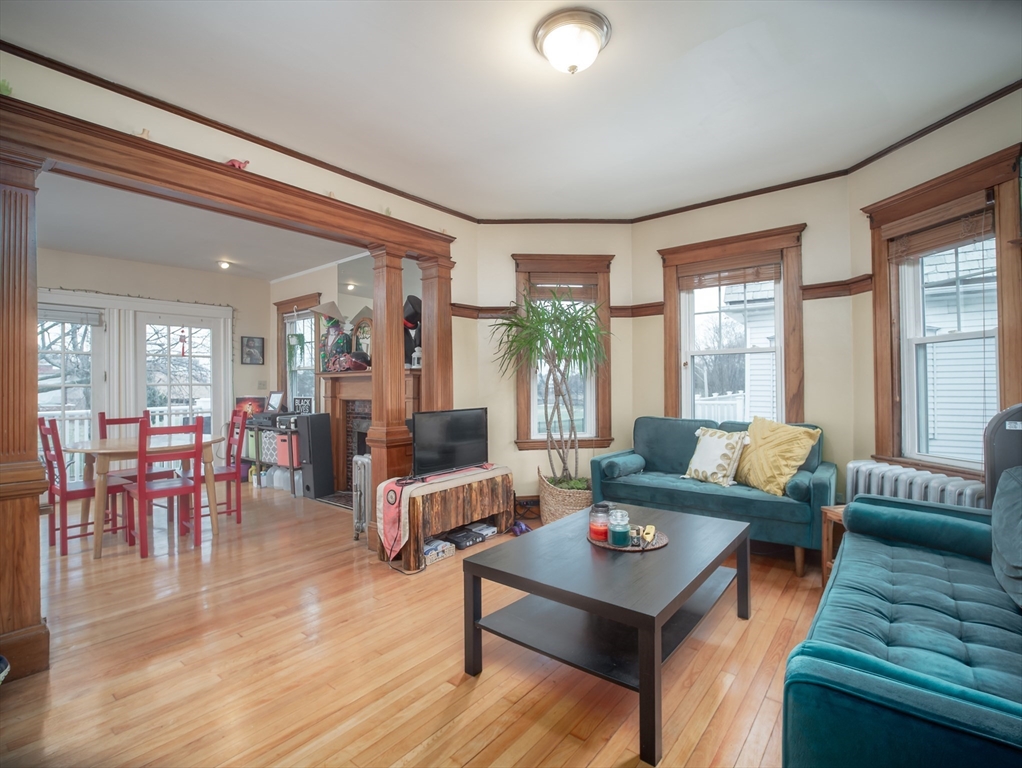 60 Powder House Boulevard, Unit 2 Somerville, MA 02144 - Photo 5 of 42 a living room with furniture and wooden floor