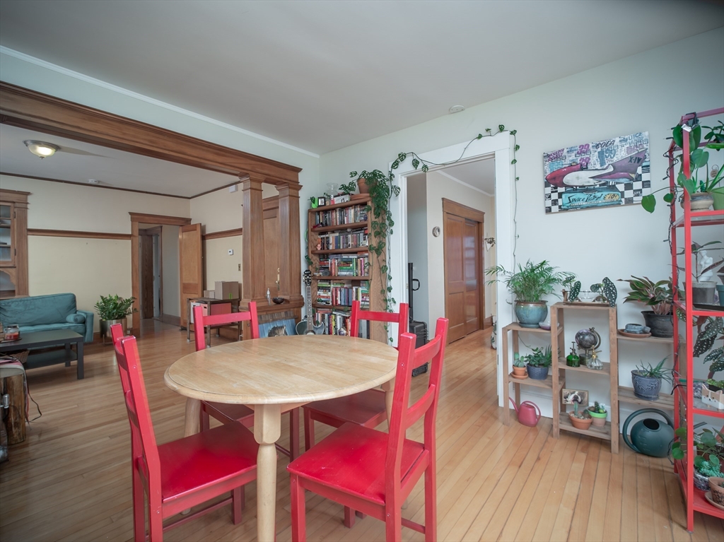 60 Powder House Boulevard, Unit 2 Somerville, MA 02144 - Photo 8 of 42 a view of a dining room with furniture and wooden floor