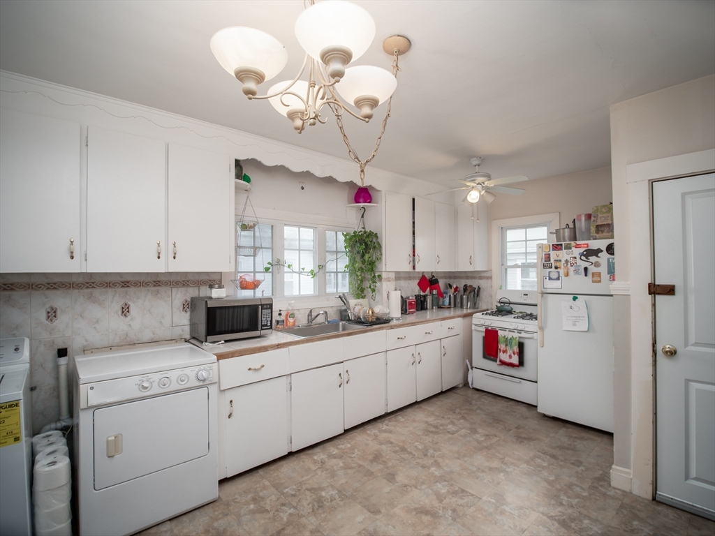 60 Powder House Boulevard, Unit 2 Somerville, MA 02144 - Photo 10 of 42 a kitchen that has cabinets a sink and dishwasher