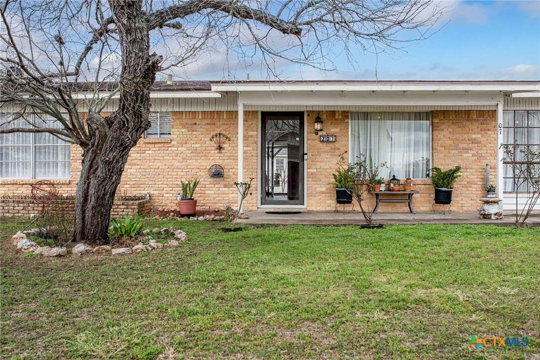 207 Williams Street Tivoli, TX 77990 - Photo 2 of 32 a front view of a house with a garden
