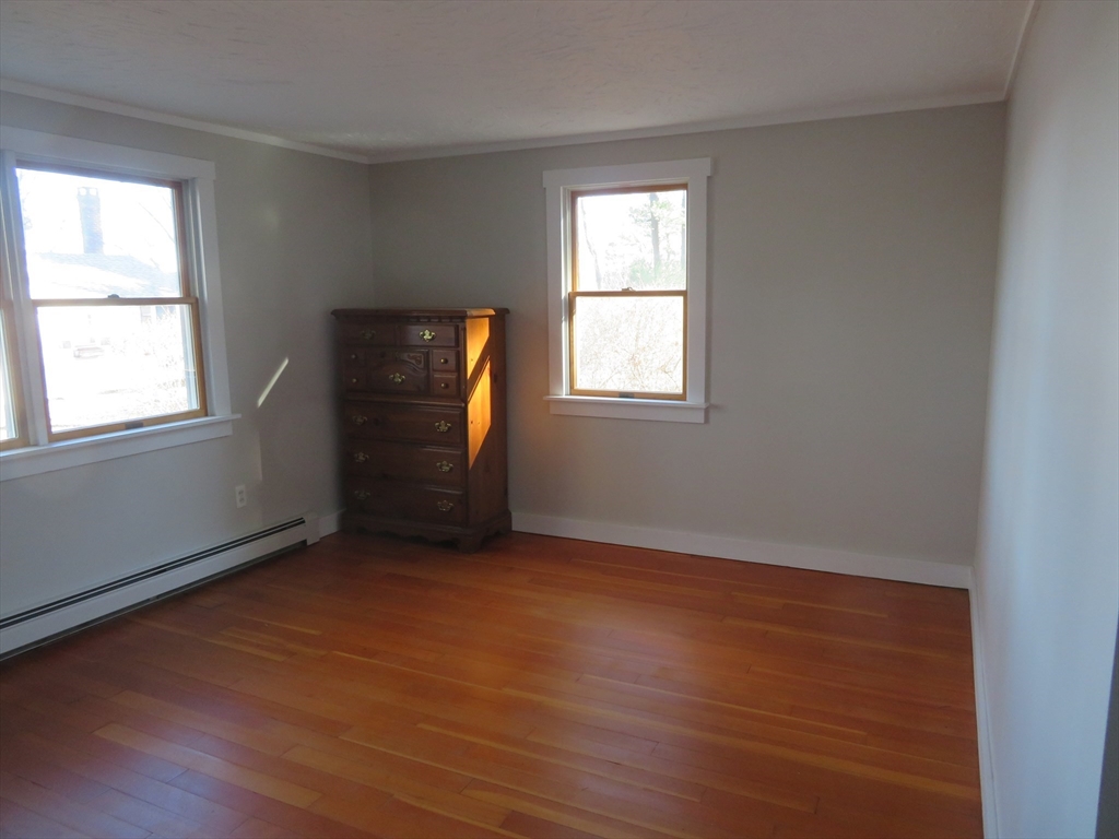 103 King Philip Road Norton, MA 02766 - Photo 14 of 37 an empty room with wooden floor and windows