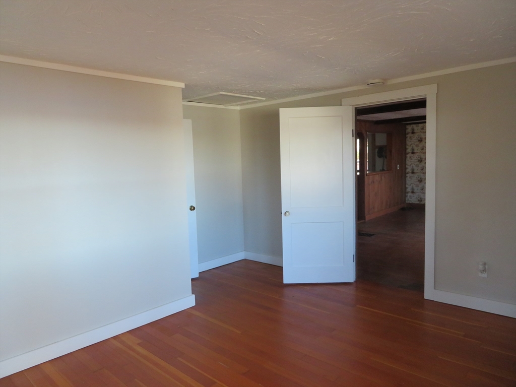 103 King Philip Road Norton, MA 02766 - Photo 15 of 37 a view of an empty room with wooden floor
