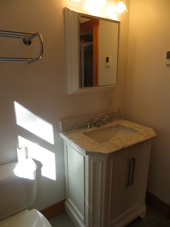 103 King Philip Road Norton, MA 02766 - Photo 22 of 37 a bathroom with a granite countertop sink and mirror with toilet