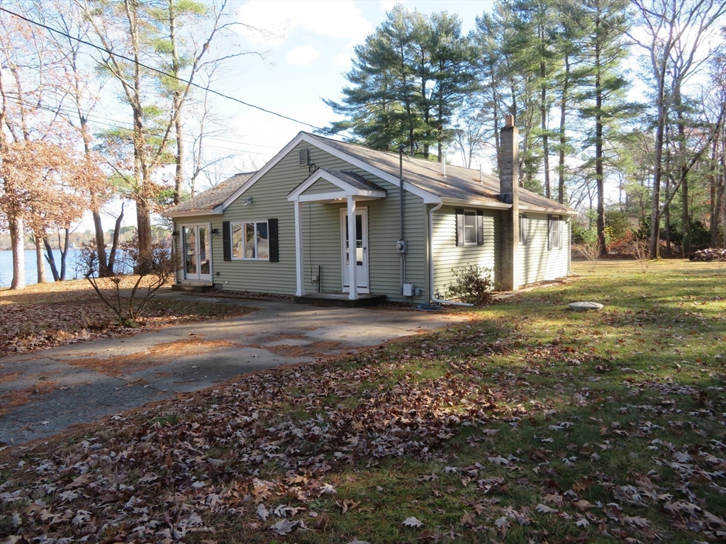 103 King Philip Road Norton, MA 02766 - Photo 4 of 37 a front view of a house with a garden