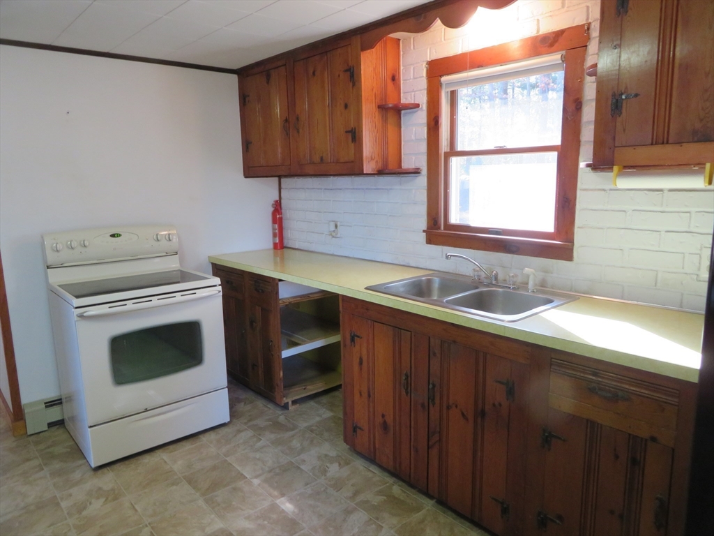 103 King Philip Road Norton, MA 02766 - Photo 5 of 37 a kitchen with a stove and a sink