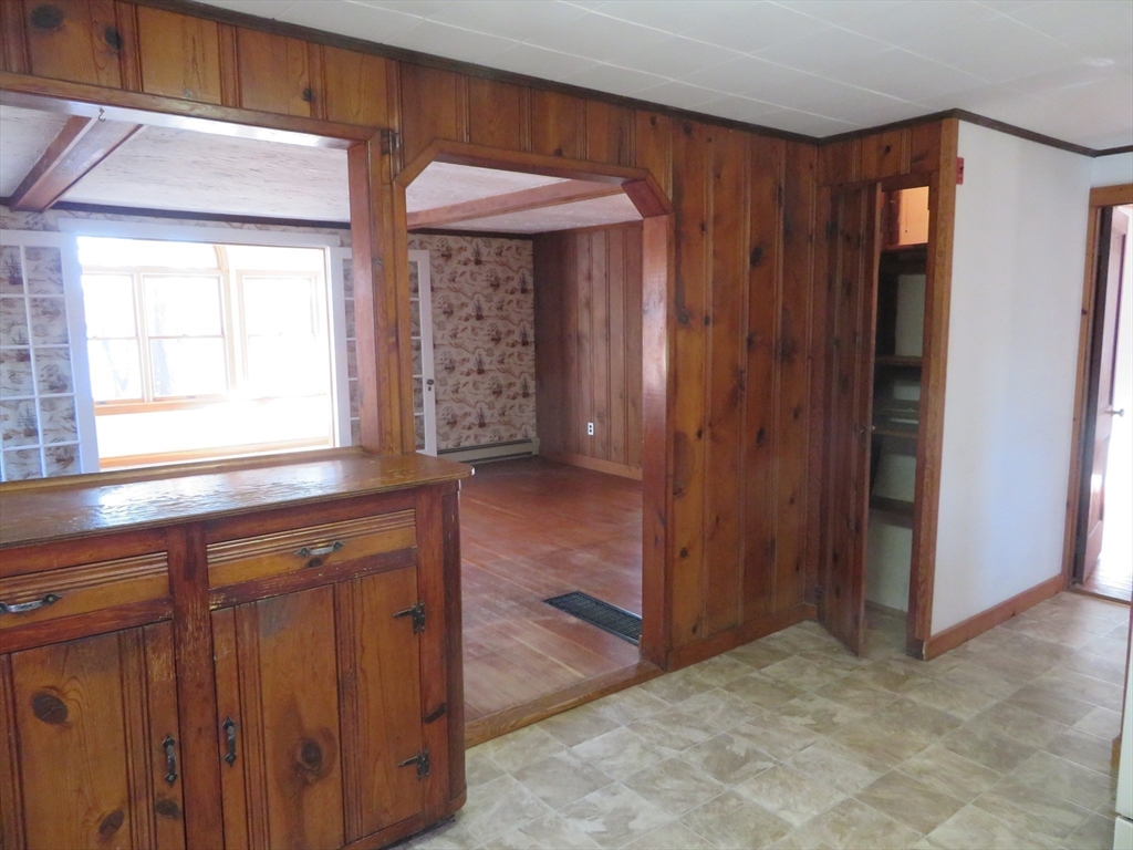 103 King Philip Road Norton, MA 02766 - Photo 9 of 37 an empty room with window and wooden door