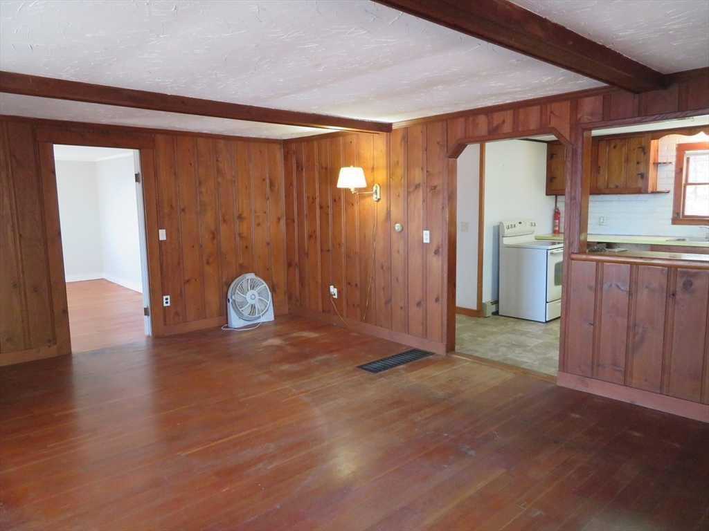103 King Philip Road Norton, MA 02766 - Photo 10 of 37 a view of a livingroom with wooden floor and kitchen space