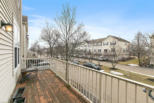 a view of a house with wooden deck and trees