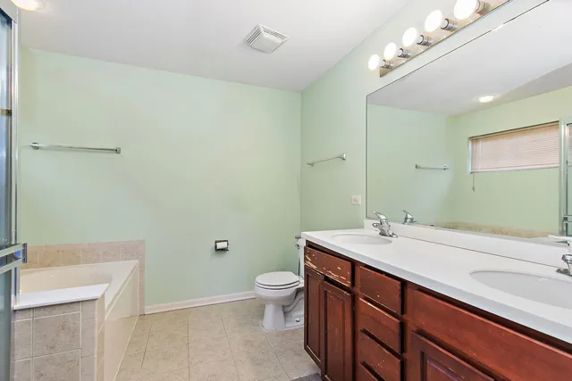 a bathroom with a sink a toilet a mirror and vanity