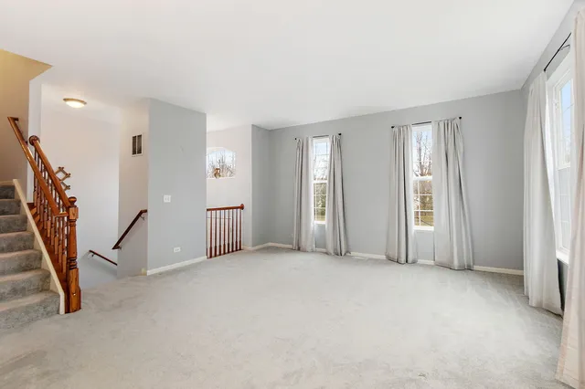 a view of empty room with stairs
