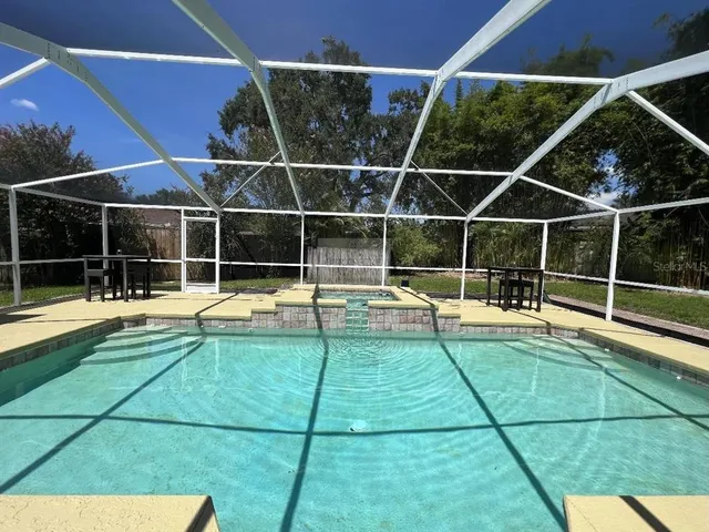 a view of a backyard with a swimming pool