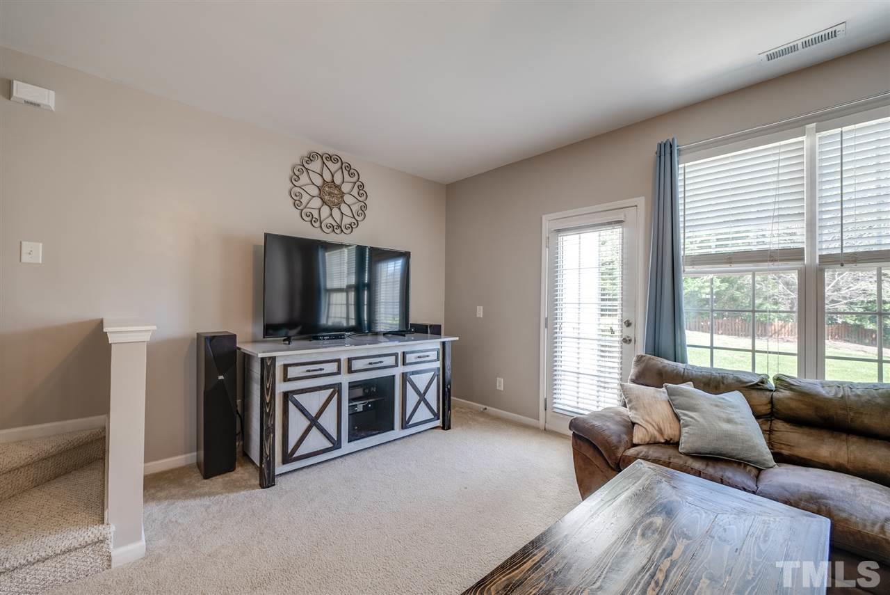 8460 Reedy Ridge Lane Raleigh, NC 27613 - Photo 11 of 22 a living room with furniture and a flat screen tv