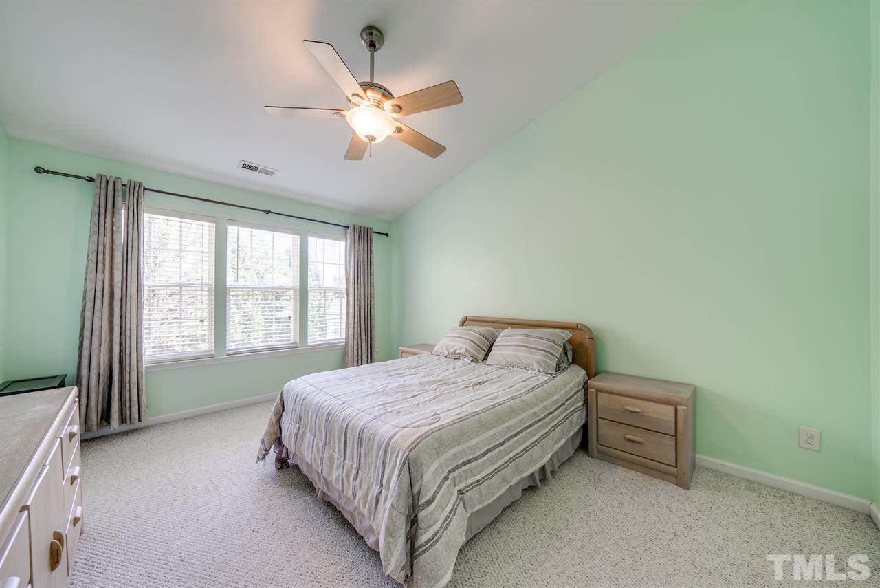 8460 Reedy Ridge Lane Raleigh, NC 27613 - Photo 13 of 22 a bedroom with a bed and a large window