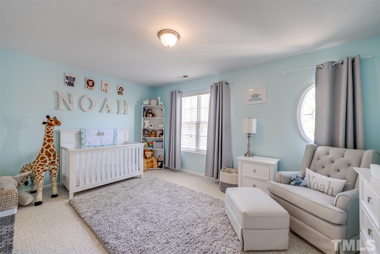 8460 Reedy Ridge Lane Raleigh, NC 27613 - Photo 17 of 22 a bedroom with furniture and a large window