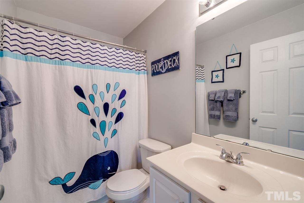 8460 Reedy Ridge Lane Raleigh, NC 27613 - Photo 19 of 22 a bathroom with a sink a toilet and vanity