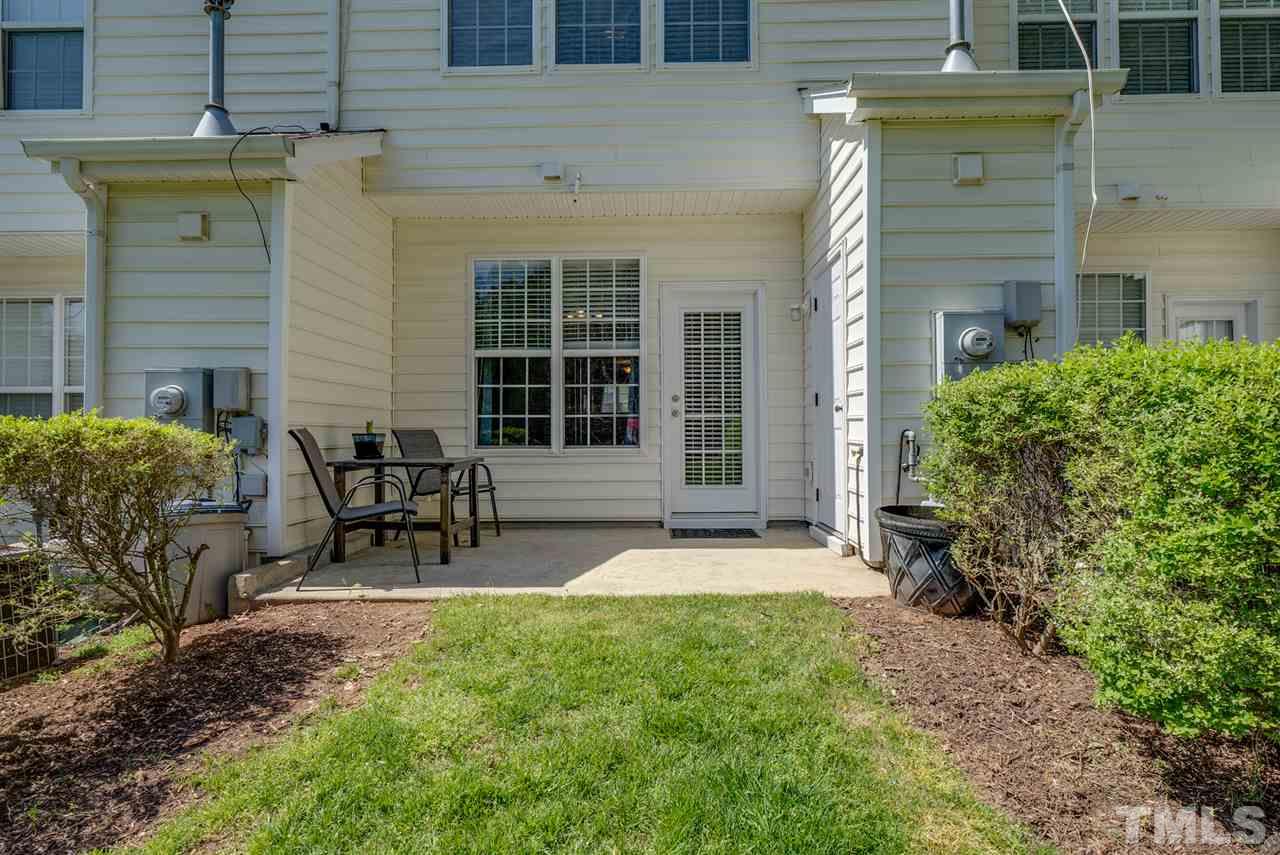 8460 Reedy Ridge Lane Raleigh, NC 27613 - Photo 20 of 22 a view of a brick house with chairs and table in a patio
