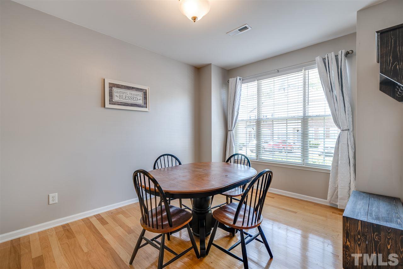8460 Reedy Ridge Lane Raleigh, NC 27613 - Photo 3 of 22 a dining room with furniture and wooden floor