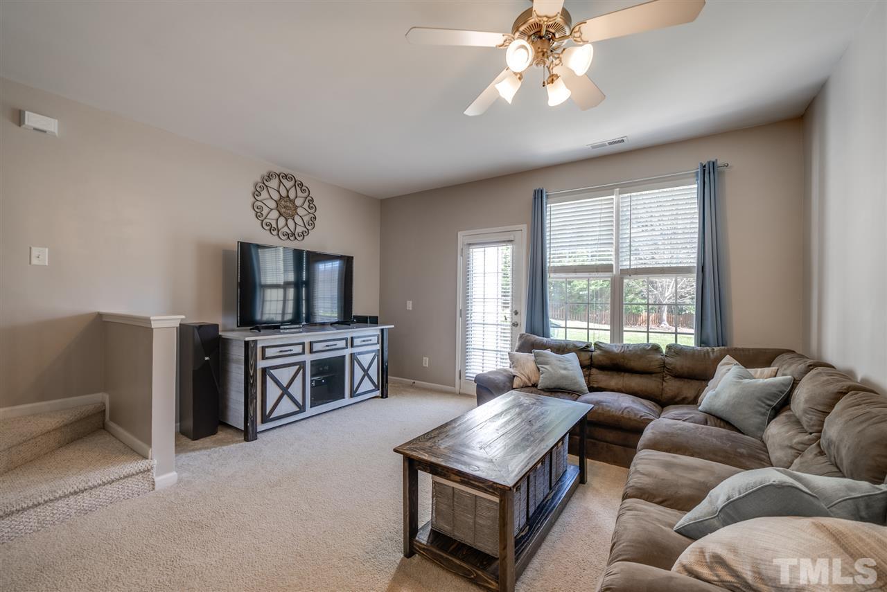 8460 Reedy Ridge Lane Raleigh, NC 27613 - Photo 10 of 22 a living room with furniture and a flat screen tv