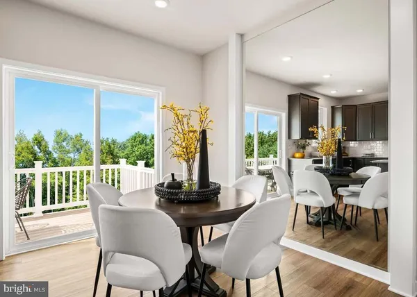 a dining room with furniture window and wooden floor