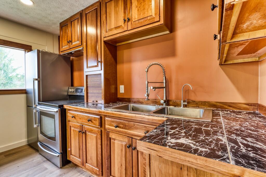 1011 Wilson Cemetery Road Northeast Check, VA 24072 - Photo 13 of 41 a kitchen with stainless steel appliances granite countertop a stove a sink and a refrigerator