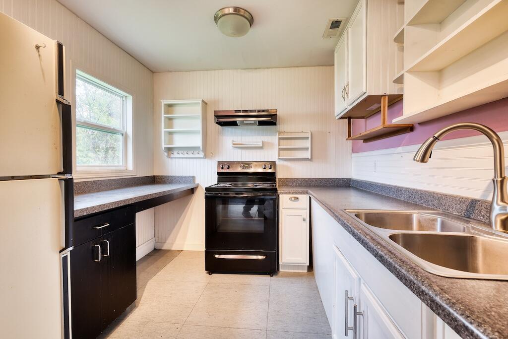 1011 Wilson Cemetery Road Northeast Check, VA 24072 - Photo 19 of 41 a kitchen with stainless steel appliances granite countertop a sink stove and refrigerator
