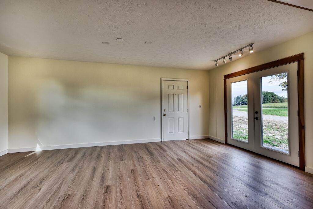 1011 Wilson Cemetery Road Northeast Check, VA 24072 - Photo 28 of 41 an empty room with wooden floor and windows