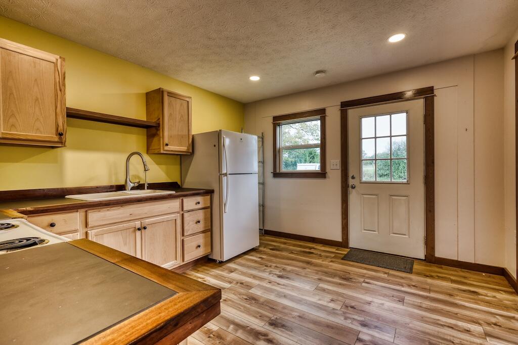 1011 Wilson Cemetery Road Northeast Check, VA 24072 - Photo 7 of 41 a kitchen with sink a refrigerator and window