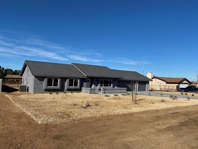 11976 Wapato Road Apple Valley, CA 92308 - Photo 1 of 1 a front view of a house with a yard