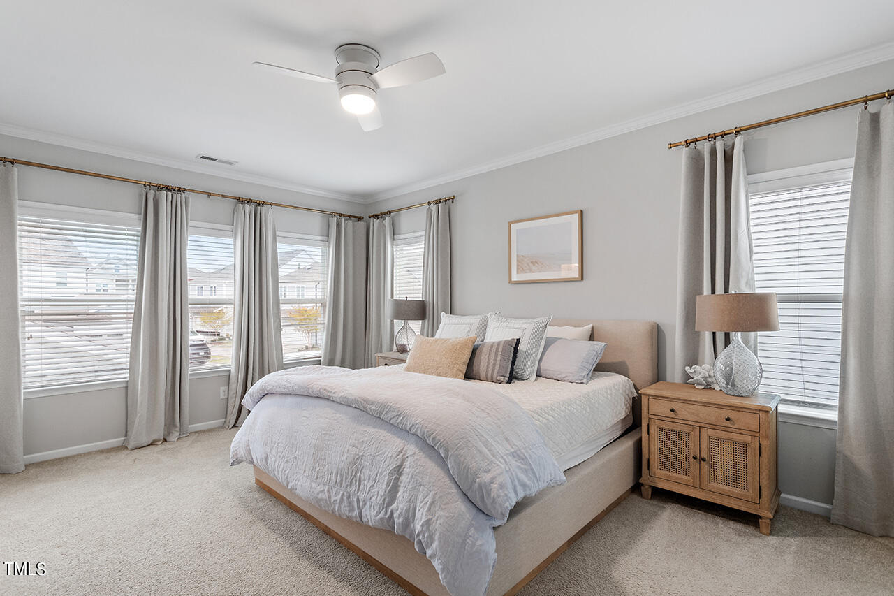 1616 Upper Park Road Wake Forest, NC 27587 - Photo 12 of 20 a large bedroom with a bed a chandelier and a large window