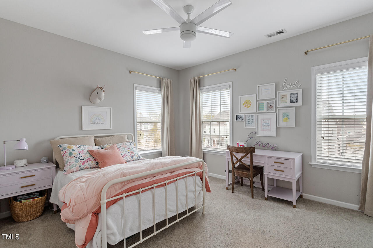 1616 Upper Park Road Wake Forest, NC 27587 - Photo 17 of 20 a bedroom with a bed and a chandelier