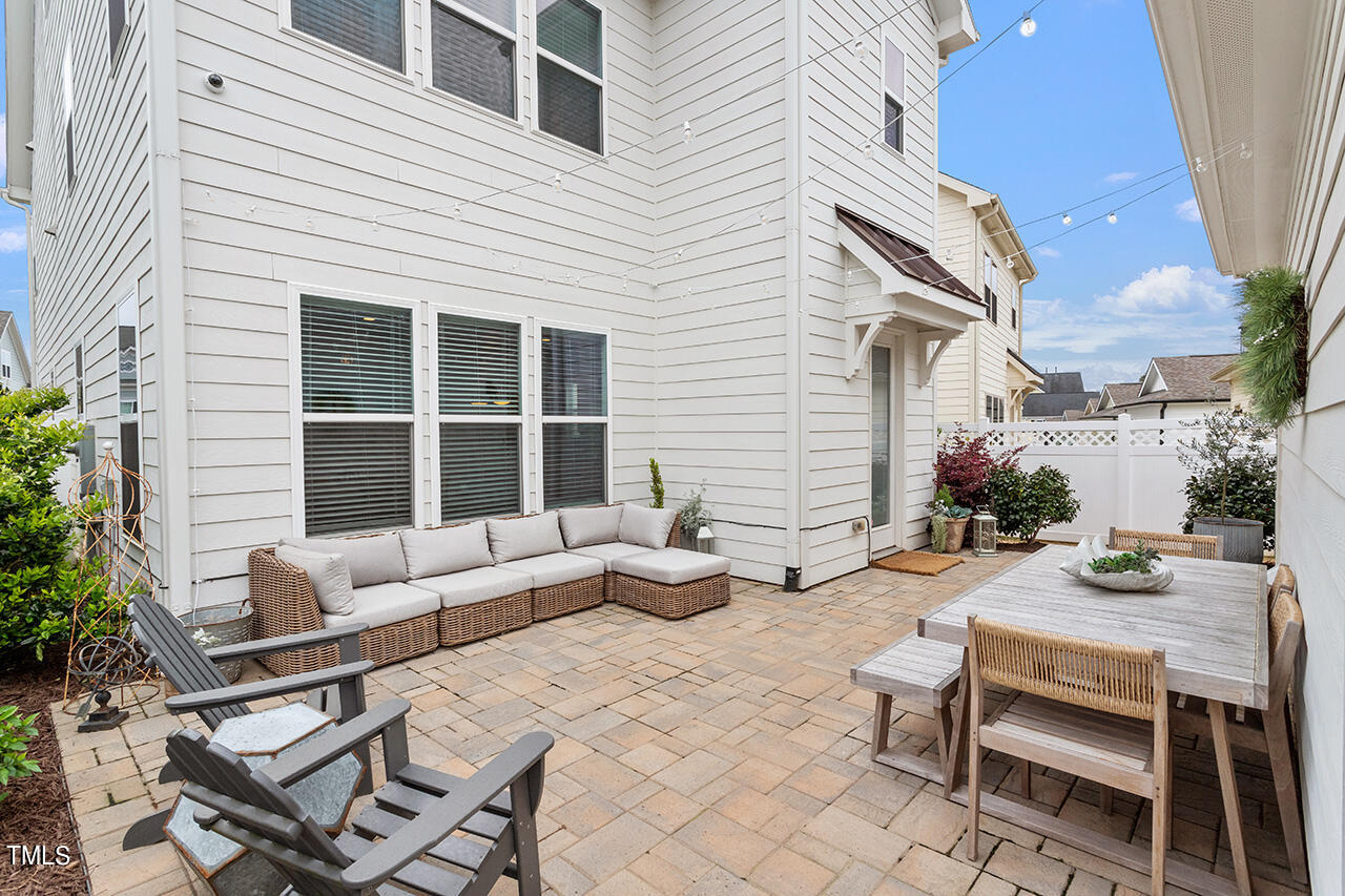 1616 Upper Park Road Wake Forest, NC 27587 - Photo 2 of 20 a view of a patio with couches table and chairs and potted plants