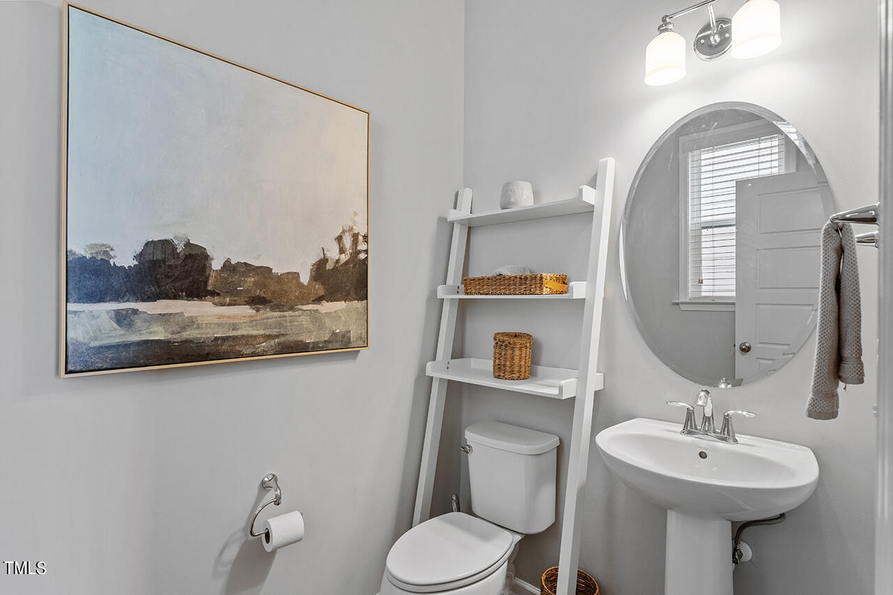 1616 Upper Park Road Wake Forest, NC 27587 - Photo 5 of 20 a bathroom with a toilet sink and mirror