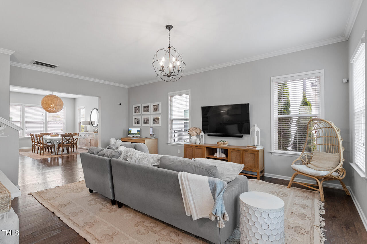 1616 Upper Park Road Wake Forest, NC 27587 - Photo 7 of 20 a living room with furniture a flat screen tv and a large window