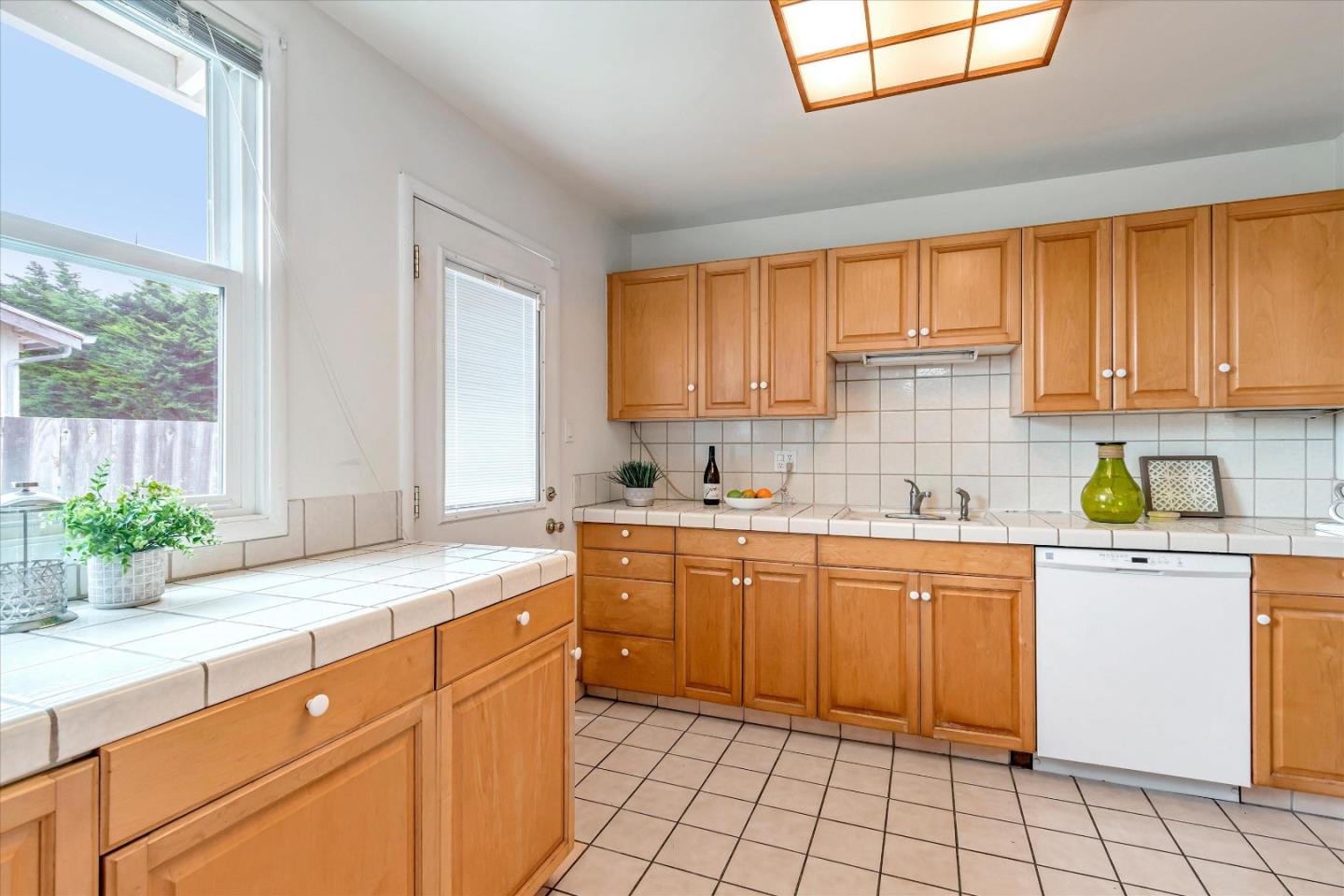 1159 De Solo Drive Pacifica, CA 94044 - Photo 11 of 45 a kitchen with sink cabinets and window