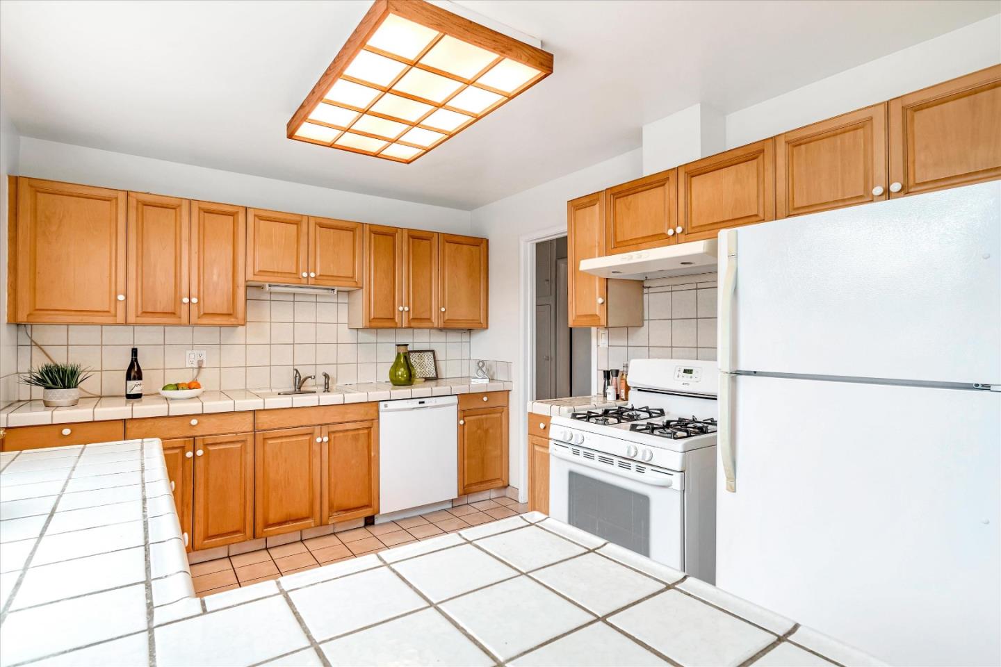 1159 De Solo Drive Pacifica, CA 94044 - Photo 13 of 45 a kitchen with a stove a sink and a refrigerator