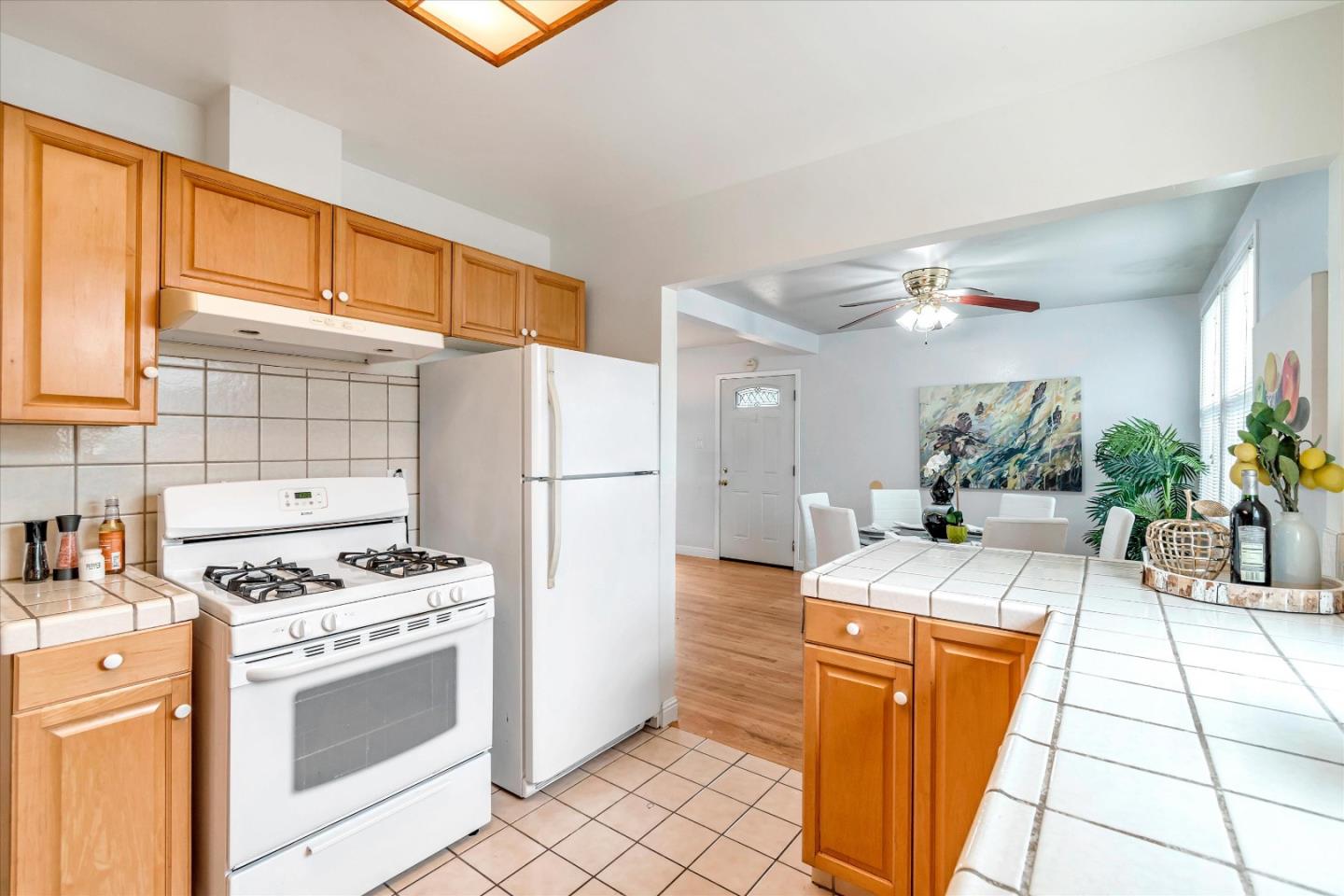 1159 De Solo Drive Pacifica, CA 94044 - Photo 17 of 45 a kitchen with stainless steel appliances kitchen island granite countertop a refrigerator a sink a stove and white cabinets