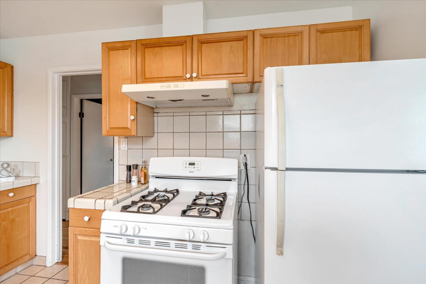 1159 De Solo Drive Pacifica, CA 94044 - Photo 18 of 45 a white refrigerator freezer sitting inside of a kitchen